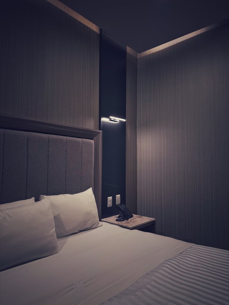 Elegant hotel room showcasing modern design and ambient lighting for a cozy stay.