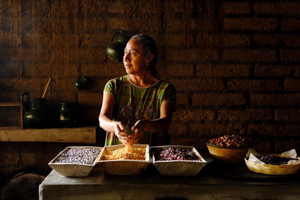 Woman preparing traditional meals with grains in Oaxaca, Mexico.
